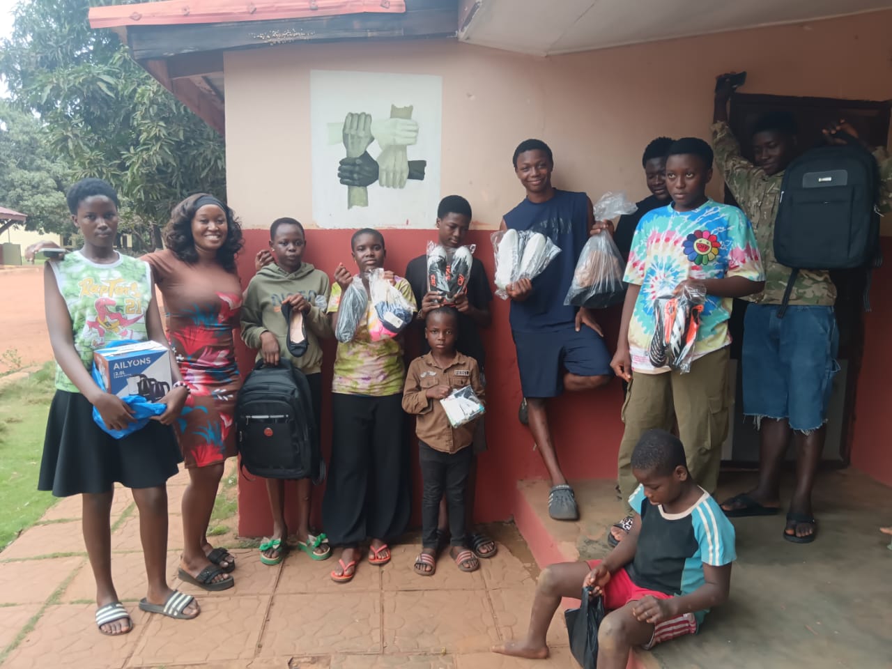 Children at Foster Home Orphanage with donated bags, shoes, and clothing